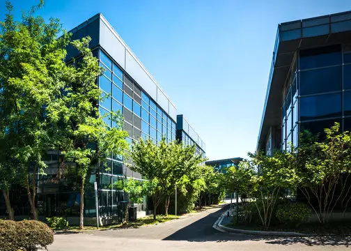 An office building complex surrounded by greenery