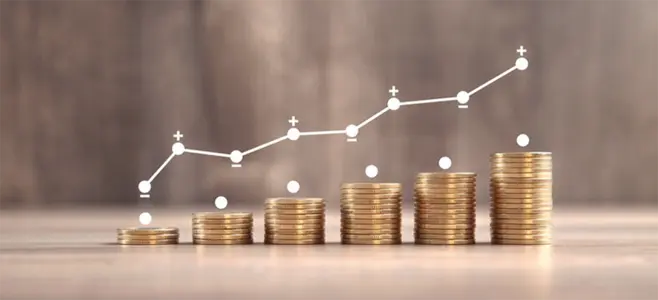 Stacks of coins with an overlaid line chart showing an upward trend